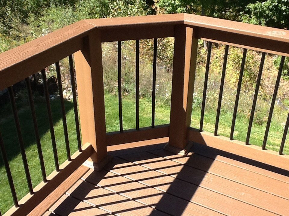 Close-up of composite deck railing and post design detail built by Supreme Deck Builders