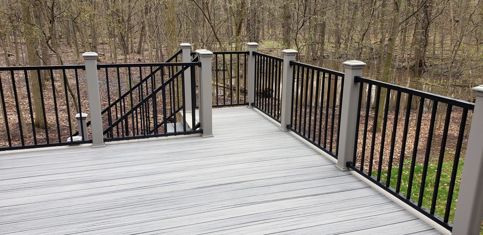 Composite deck with black aluminum railing built by Supreme Deck Builders