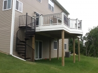 Curved deck in Trex, Transcend rails with Vintage Lantern top cap Spriral staircase